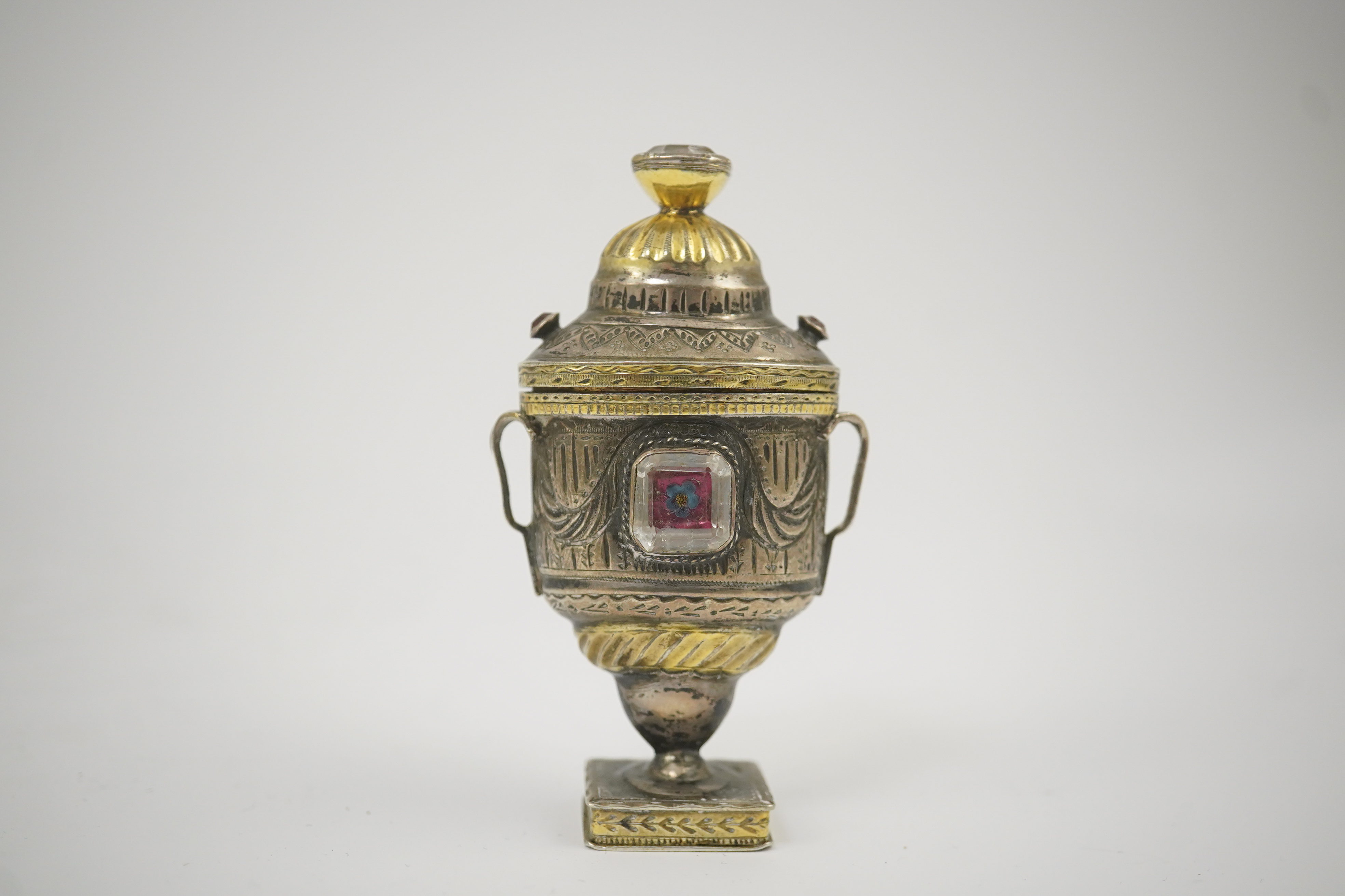 A 19th century continental parcel gilt silver and gem set double ended pill box, modelled as a two handle vase